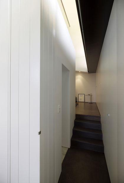 Haines House concrete stair passage, black ceiling & bathroom entry