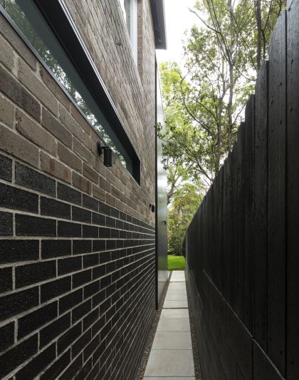 Cosgriff House side passage black bricks & highlight glazing with view to rear