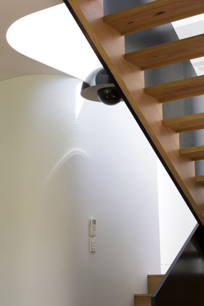 Unfurled House interior view of stair and double curved walls